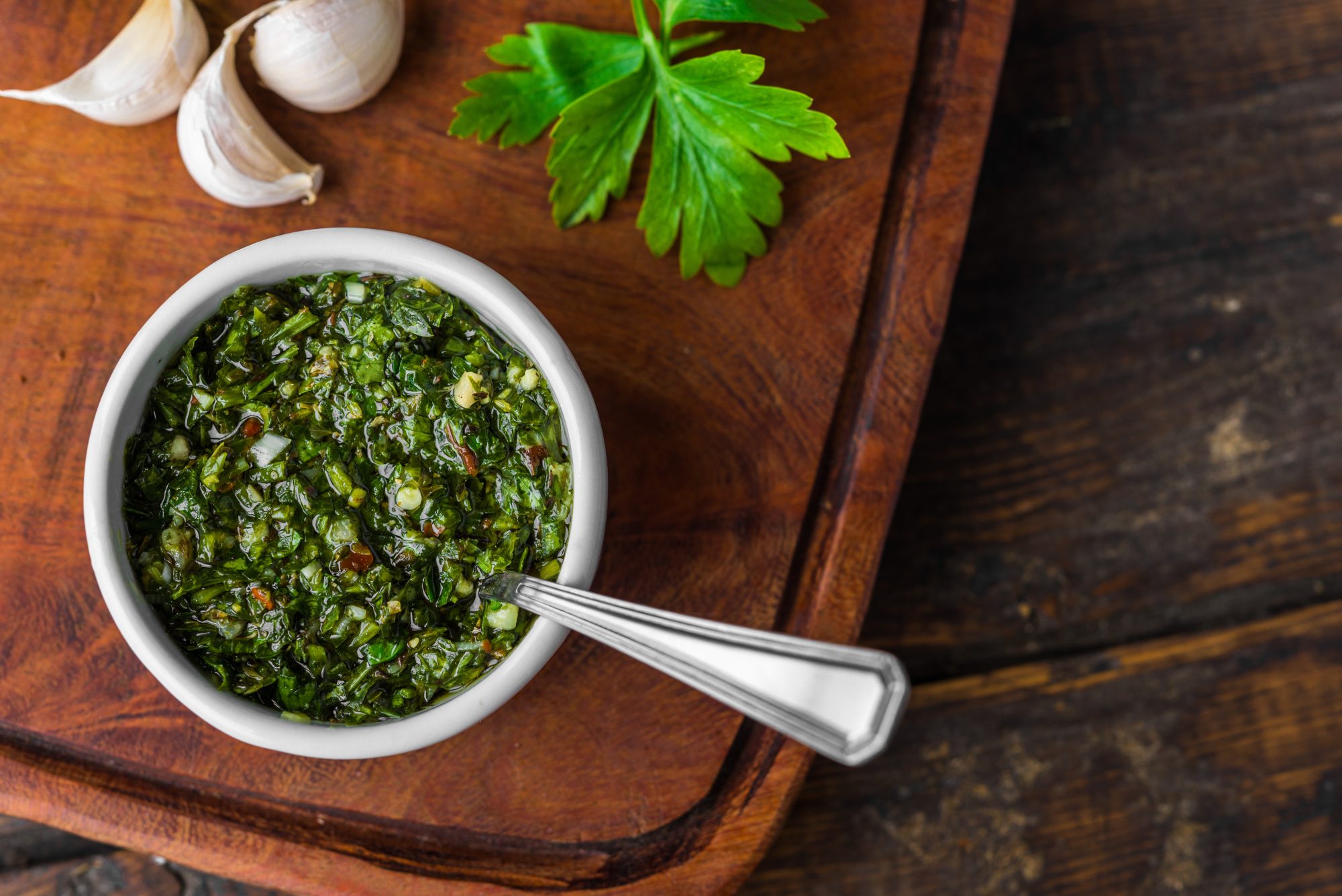 Chimichurri sauce against wooden background